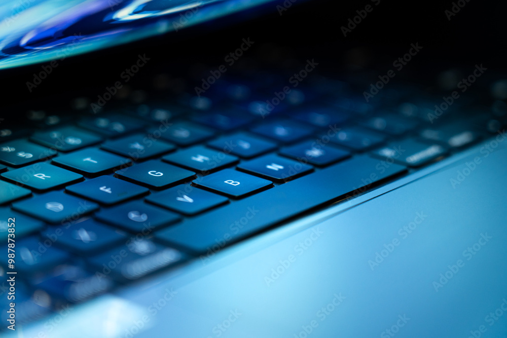 Close-up of Laptop Keyboard with Blue Lighting Close-up of Laptop Keyboard with Blue Lighting