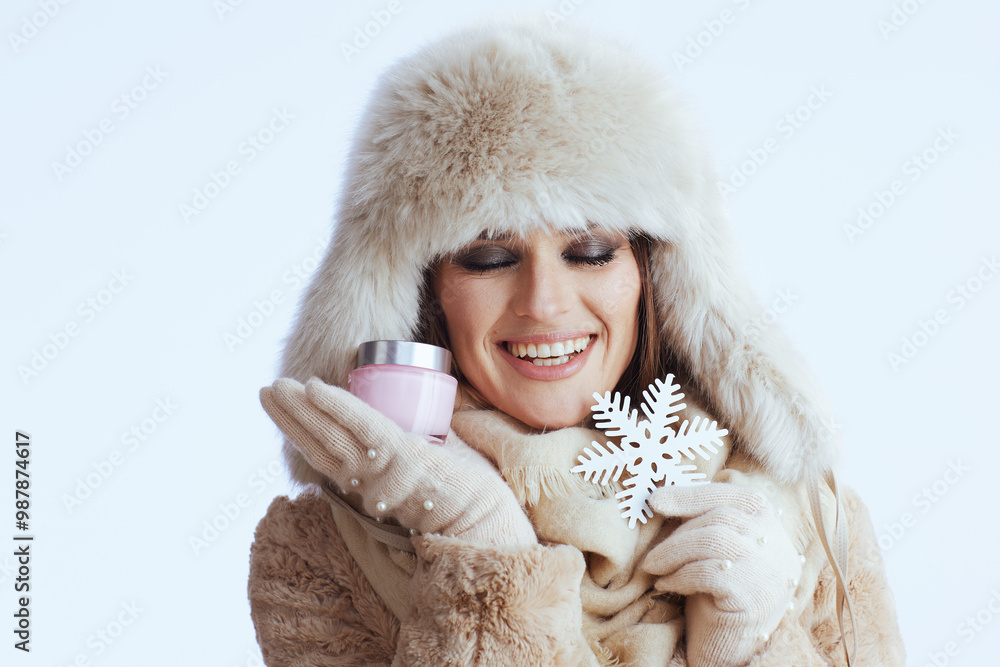 smiling modern woman in winter coat and fur hat on white smiling modern woman in winter coat and fur hat on white