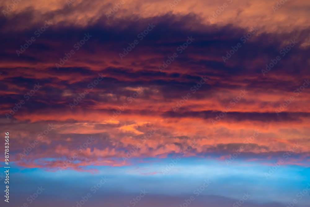 Fototapeta premium Crimson clouds in blue sky at sunset