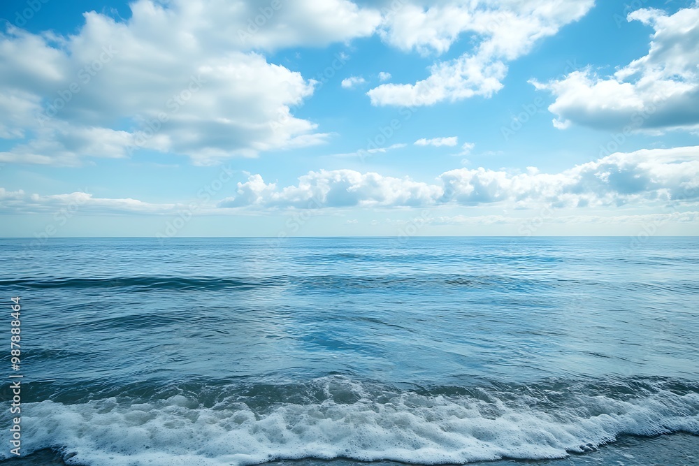 Peaceful seascape with blue sky, clouds, and calm waves Peaceful seascape with blue sky, clouds, and calm waves