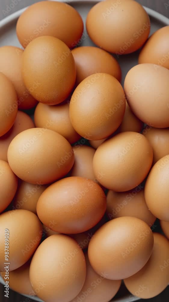 Farm fresh eggs rest in cozy carton rotating. Macro video showcasing fresh eggs nestled in delicate paper tray. Vertical footage for stories. Top view. Healthy nutrition. Organic food. Close-up in 4K Farm fresh eggs rest in cozy carton rotating. Macro video showcasing fresh eggs nestled in delicate paper tray. Vertical footage for stories. Top view. Healthy nutrition. Organic food. Close-up in 4K