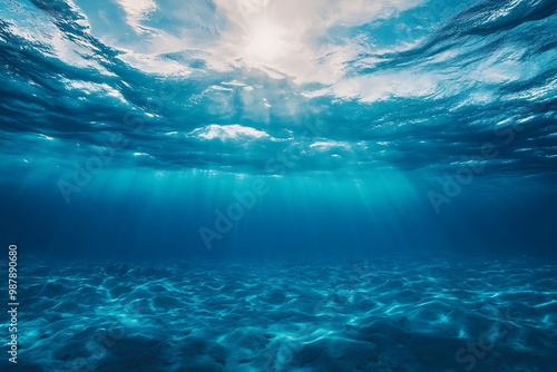 Sunbeams shining through ocean water, underwater view