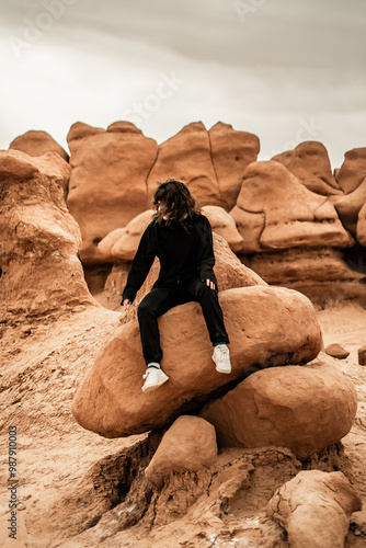 Girl Sitting on Rock Goblin Valley Utah photo