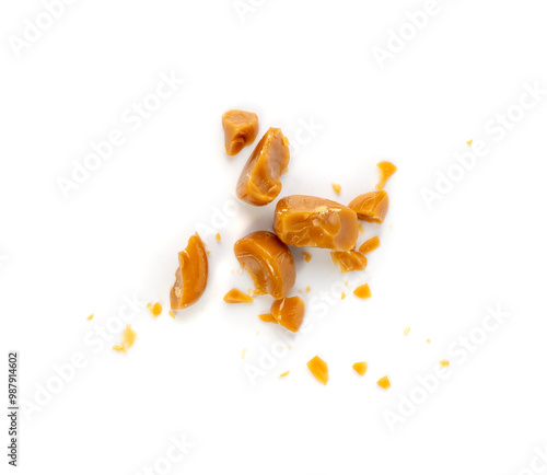 Broken caramel candies isolated, toffee caramel crumbs, round hard milk confectionery pieces