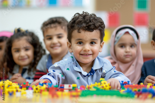 Photography of children portrait from Saudi Arabia in a preschool or kindergarten class.	 photo