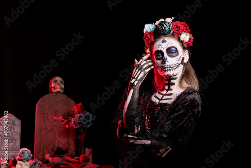 Portrait of woman participating in Day of the Dead Mexican event honoring dead loved ones, building ofrendas for them. Person doing ancient Aztec custom of celebrating ancestors, wearing flower wreath