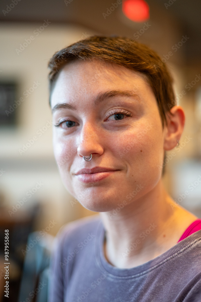 portrait of a girl with a nose ring and a purple shirt, short hair, happy and smiling. portrait of a girl with a nose ring and a purple shirt, short hair, happy and smiling.