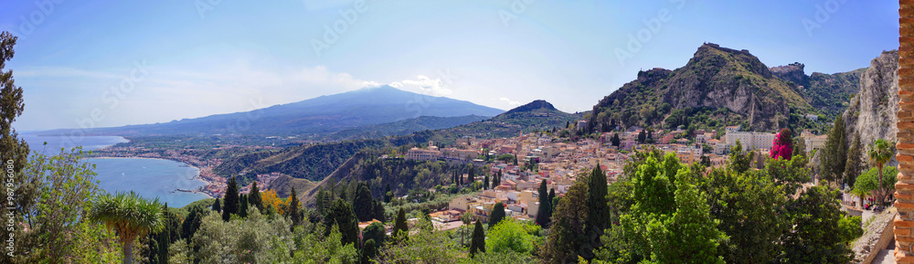 Fototapeta premium Coast of Sicily, Giardini Naxos and Taormina view. Landscape panorama with Mount Etna in the back on a sunny summer day. 