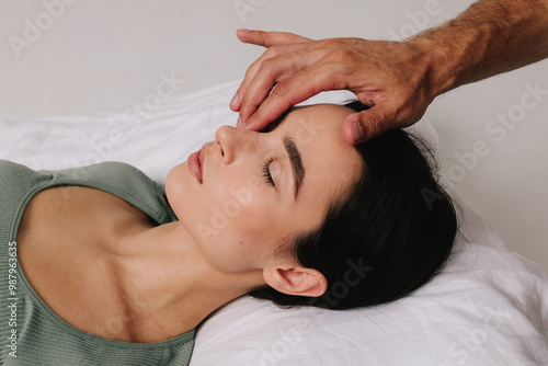 Post-surgery rhinoplasty care. Woman is having her nose taped after nose surgery. Preventing swelling, deforming and additional complications with special nose band aid.