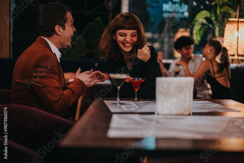 A joyful group of friends sharing laughter and drinks in a trendy bar. Highlighting friendship, fun, and socializing in a lively atmosphere.