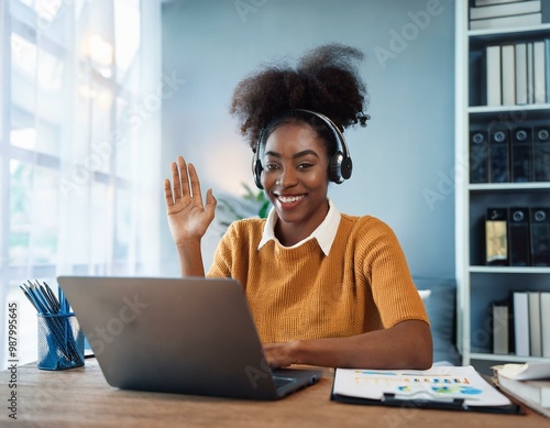 Happy african American woman working remotely on a virtual video team meeting call, remote work and flexible culture concept. Inclusive and diverse workplace. DEI remote working. AI