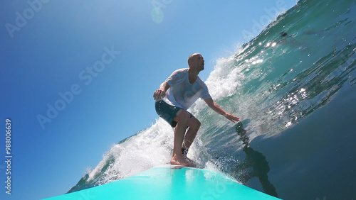 Canvas Print Man surfing a glassy wave on a blue board