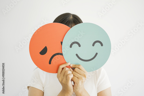 Cuadro en lienzo Woman hands holding sad face hiding behind happy face, bipolar and depression, m