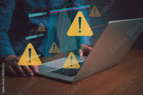 Businessmen use laptops with virtual warning signs warning them about visiting potentially dangerous websites or clicking on links that hackers could expose financial transactions and more