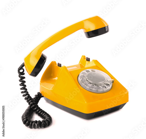 Old yellow telephone with rotary dial isolated on white photo