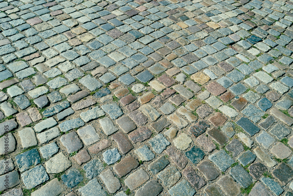 Fototapeta premium Background of bricks road. Background with bricks road. Stone cladding pavement. Brick surface background. Rough brick road. Stone pavement texture.