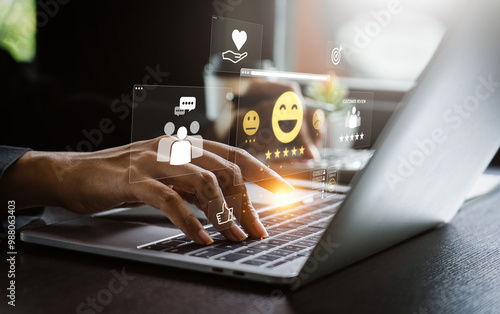 User Typing on Laptop to Submit Customer Feedback with Digital Satisfaction Ratings, Featuring Virtual Icons for Positive Review, Customer Service, and Online Consumer Interaction in Business Platform photo