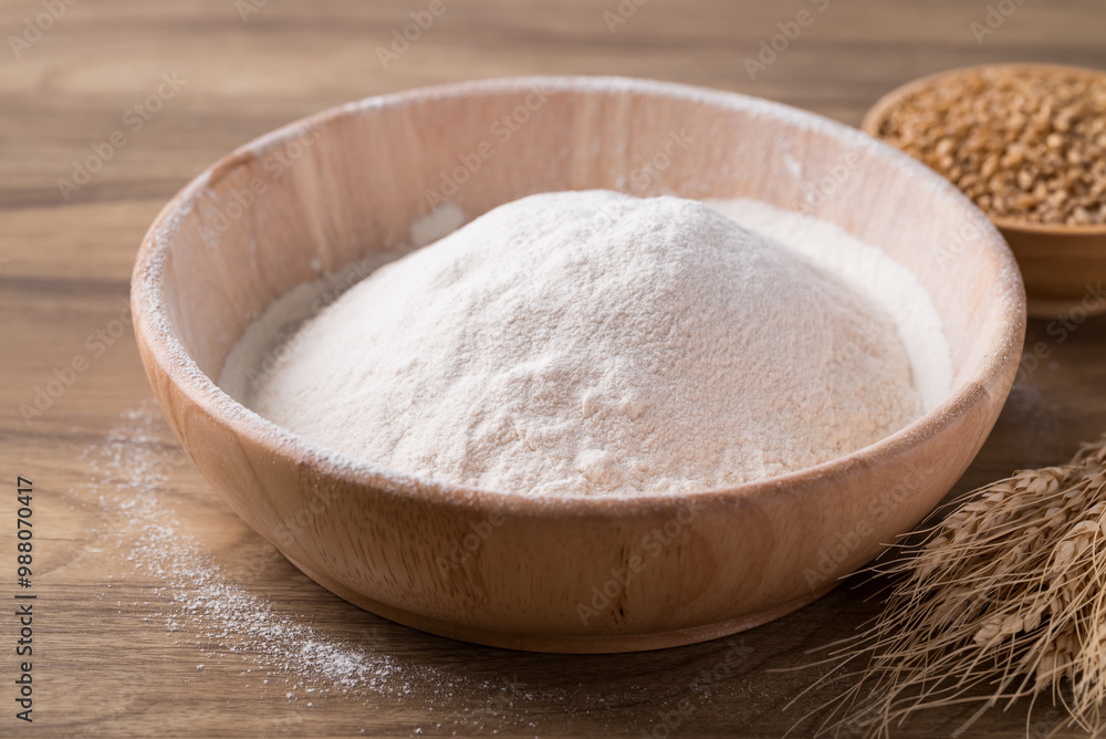 Wheat flour in bowl with wheat grain on wooden background, Food ingredient Wheat flour in bowl with wheat grain on wooden background, Food ingredient