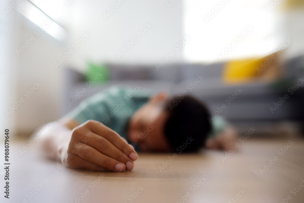 Close Up of Person Hands Fainting Lying on The Floor Against Blurred Background