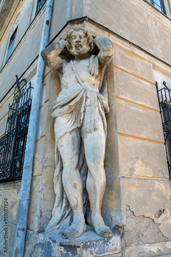 Giant statue of Atlas or Corgon, supporting the floor of the palace Kluch in Nitra. Slovakia. photo