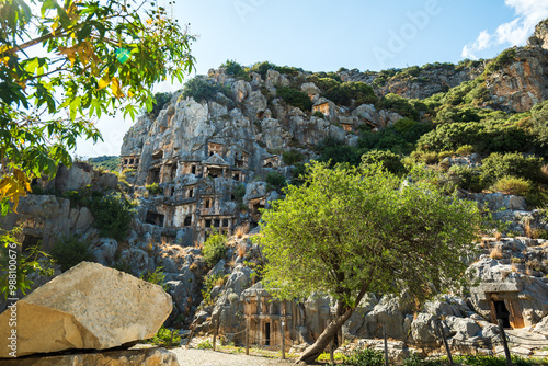 Myra archaeological site with rock tombs in Demre, Turkey. The Ancient City of Myra is especially famous for its Lycian-Era rock tombs, Roman-Era theatre photo