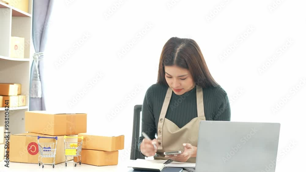 Female SME business owner entrepreneur working on receipt boxes and checking online orders to prepare to pack boxes, sell to customers. Online SME business concept, small business startup. Female SME business owner entrepreneur working on receipt boxes and checking online orders to prepare to pack boxes, sell to customers. Online SME business concept, small business startup.