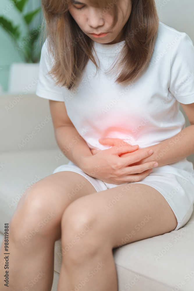 woman having abdomen ache due to Stomach pain, digestion with constipation or Diarrhea from food poisoning, female problem and Endometriosis, Hysterectomy, Stomachache and Menstrual on sofa at home woman having abdomen ache due to Stomach pain, digestion with constipation or Diarrhea from food poisoning, female problem and Endometriosis, Hysterectomy, Stomachache and Menstrual on sofa at home