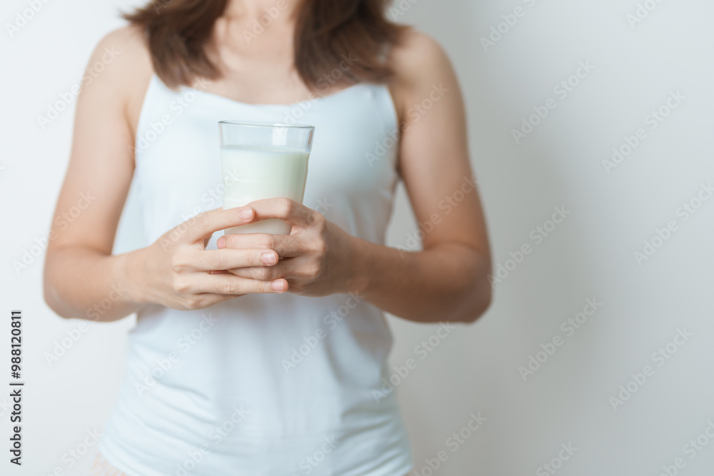 Milk drink and Daily Routine concept. Young woman Drinking milk with high calcium and nutrition at home, woman holding soy milk on glass with protein. Healthy, wellness and happy lifestyle Milk drink and Daily Routine concept. Young woman Drinking milk with high calcium and nutrition at home, woman holding soy milk on glass with protein. Healthy, wellness and happy lifestyle