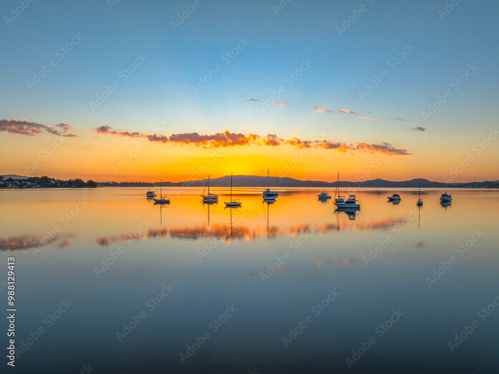 Autumn sunrise over the bay with boats and reflections Autumn sunrise over the bay with boats and reflections