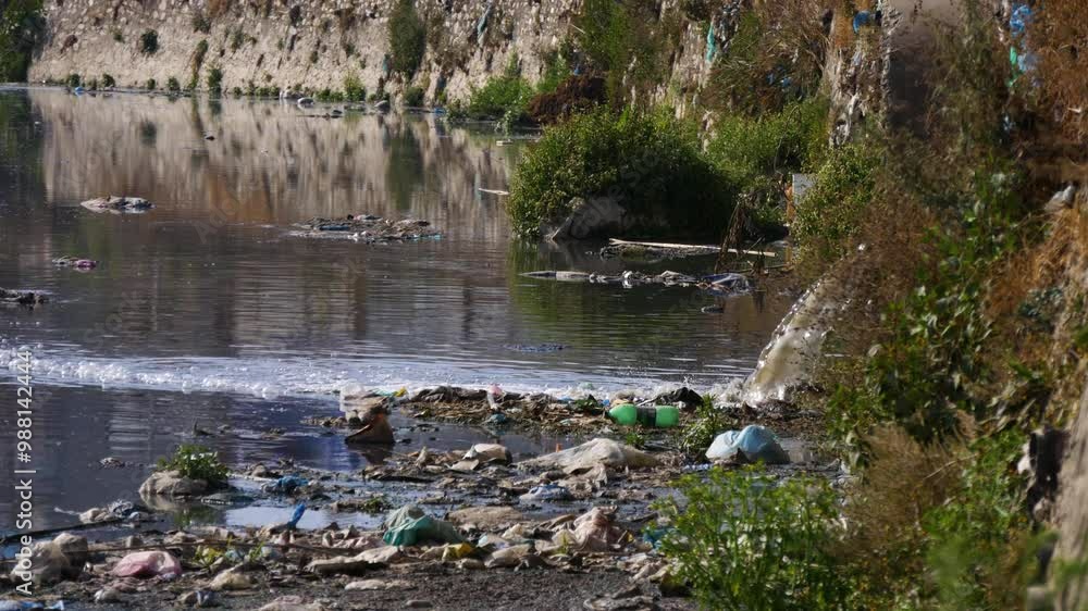 Draining city sewage into river resulting water pollution and lots of plastic pollution in river.