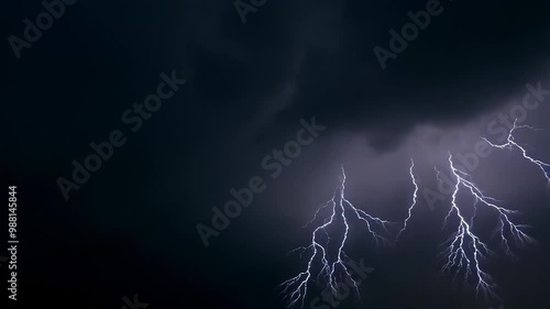 Thunderstorm flashes with multiple bolts of lightning on dark cloudy sky