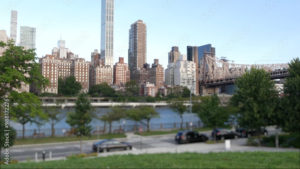 Obraz premium New York City waterfront skyline, Queensboro Bridge, Manhattan Midtown buildings, riverfront skyscrapers. Waterside cityscape view from Roosevelt Island. United States architecture and real estate.