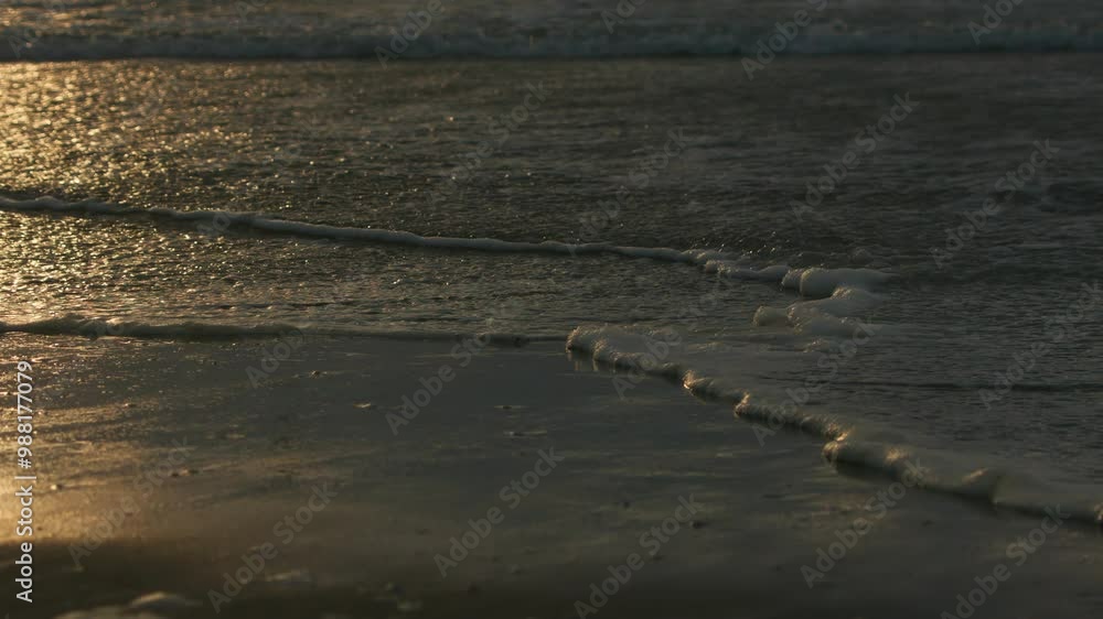 Beautiful sea waves and sand close up texture at tropical beach during golden sunset, high quality 4K slow motion travel vacation concept. Beautiful sea waves and sand close up texture at tropical beach during golden sunset, high quality 4K slow motion travel vacation concept.