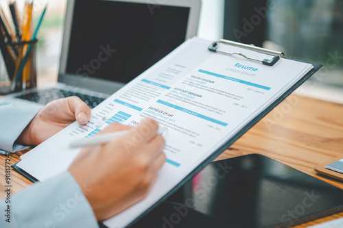 HR managers are interviewing job applicants who fill out their resume on the job application form in order to consider accepting a job as a company