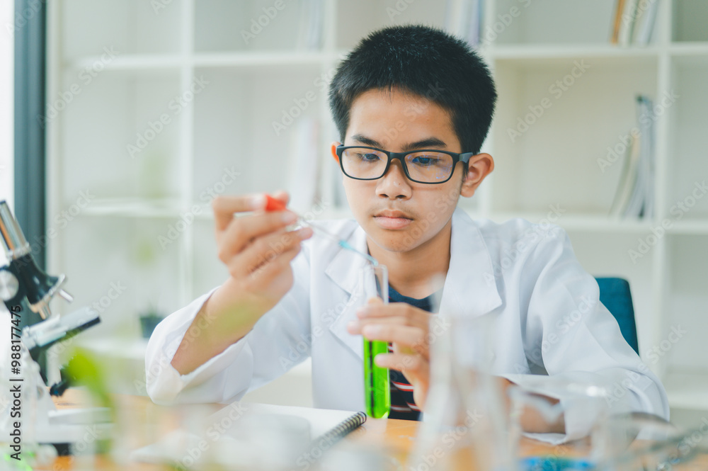 Asian male science students looking through a microscope and tests of plants in the classroom. Learning about scientific experiments on plant species. Asian male science students looking through a microscope and tests of plants in the classroom. Learning about scientific experiments on plant species.