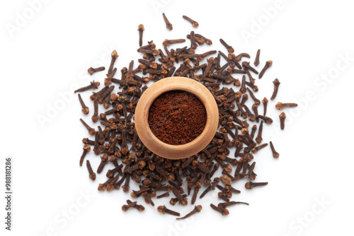 A mud pot filled with organic Clove (Syzygium aromaticum) or Indian long powder, placed on a heap of Clove buds, isolated on a white background. photo