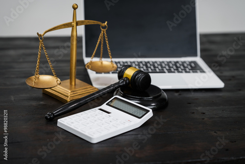 A lawyer's desk in an office,with legal documents, computers, and hammers placed neatly.The setting is organized for legal consulting services, contract reviews,will drafting,document certification