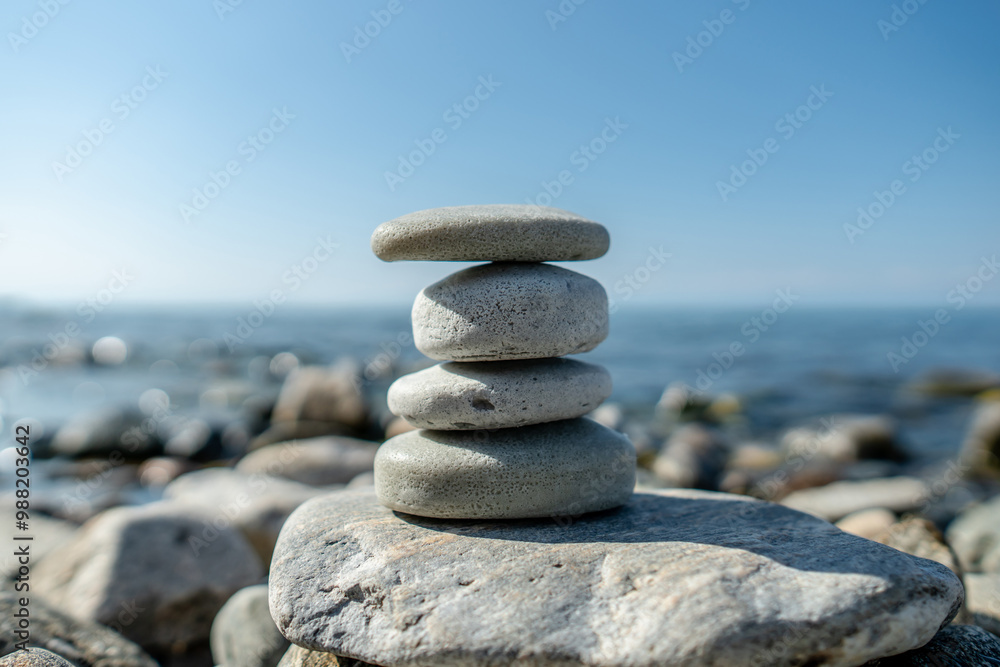 Pieces of craft soap in the shape of stones are stacked on top of each other against the background of the sea or lake. Image of organic cosmetics in a natural environment Pieces of craft soap in the shape of stones are stacked on top of each other against the background of the sea or lake. Image of organic cosmetics in a natural environment