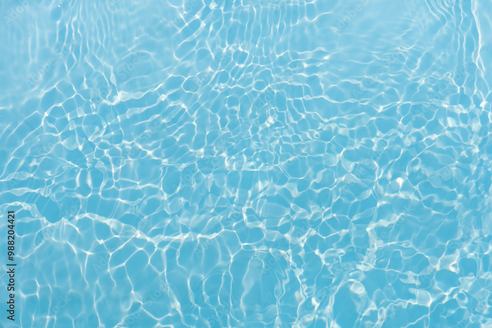 Blue water with ripples on the surface. Defocus blurred transparent blue colored clear calm water surface texture with splashes and bubbles. Water waves with shining pattern texture background. Blue water with ripples on the surface. Defocus blurred transparent blue colored clear calm water surface texture with splashes and bubbles. Water waves with shining pattern texture background.