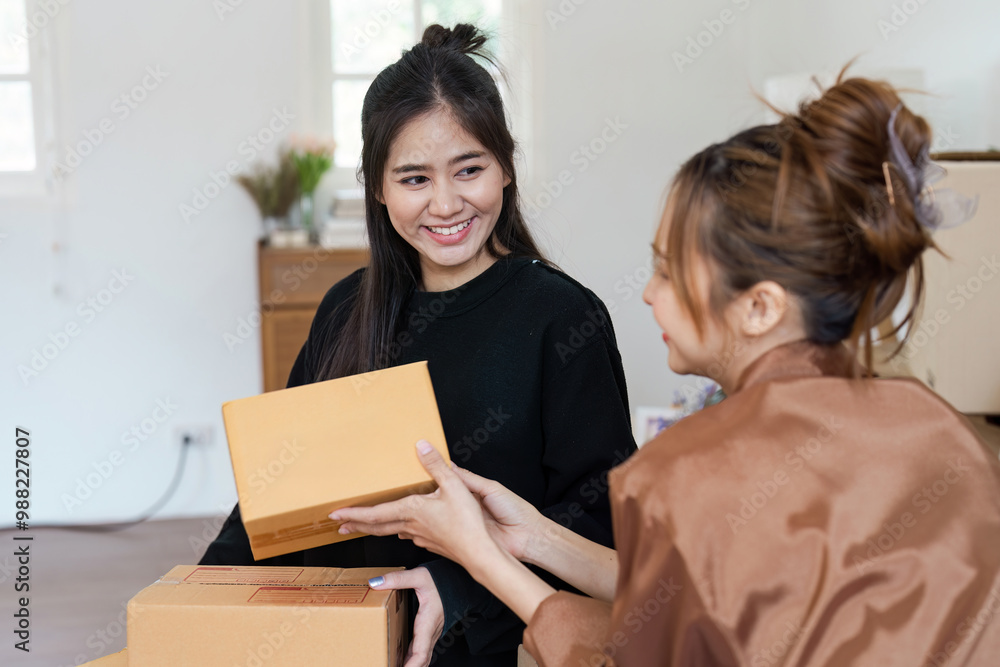 Happy Lesbian Couple Moving into New Home Unpacking Boxes and Smiling Together in Bright Modern Living Room Happy Lesbian Couple Moving into New Home Unpacking Boxes and Smiling Together in Bright Modern Living Room