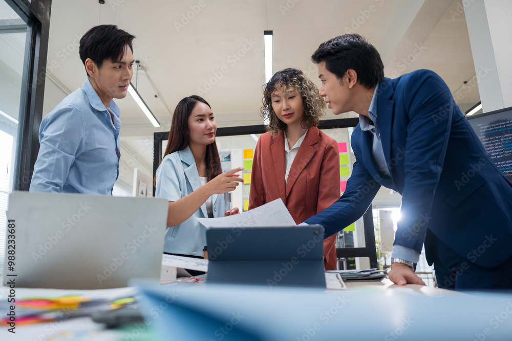 © saksit - Group of young Asian business people team meeting in modern office working design planning and ideas concept © saksit - Group of young Asian business people team meeting in modern office working design planning and ideas concept