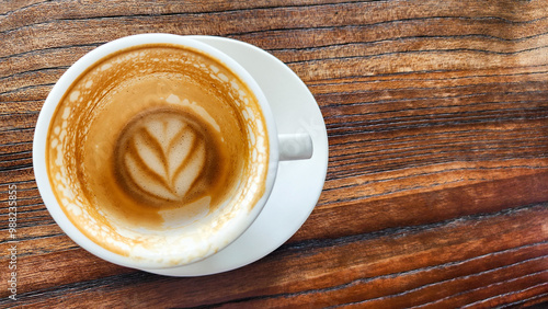 Top view latte art coffee on wood background