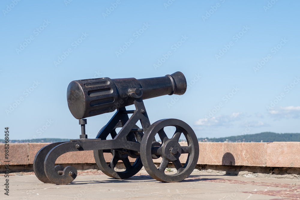This historic cannon, crafted at the Alexander factory, overlooks the beautiful embankment of Lake Onega in Petrozavodsk, reflecting local history This historic cannon, crafted at the Alexander factory, overlooks the beautiful embankment of Lake Onega in Petrozavodsk, reflecting local history