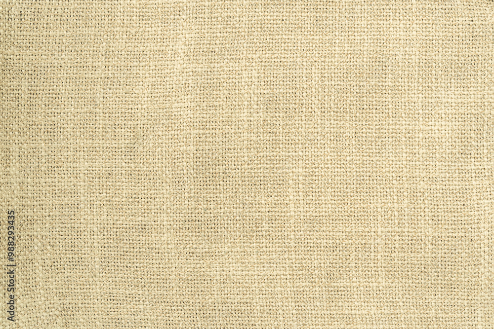 Fototapeta premium Jute hessian sackcloth woven burlap texture background in yellow beige cream color