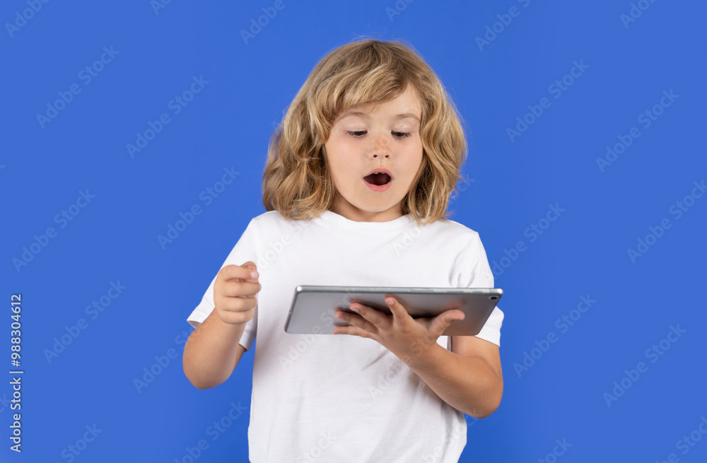 Portrait of kid with tablet. Kids gadget addiction concept. Schoolgirl Holding Digital Tablet On Isolated Background In Studio. Virtual learning with tablet. Digital education. excited kid using Portrait of kid with tablet. Kids gadget addiction concept. Schoolgirl Holding Digital Tablet On Isolated Background In Studio. Virtual learning with tablet. Digital education. excited kid using