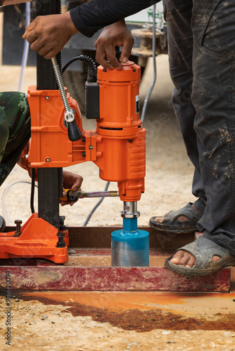 Workers are coring to check the thickness and quality of pavement-recycling road construction work. photo