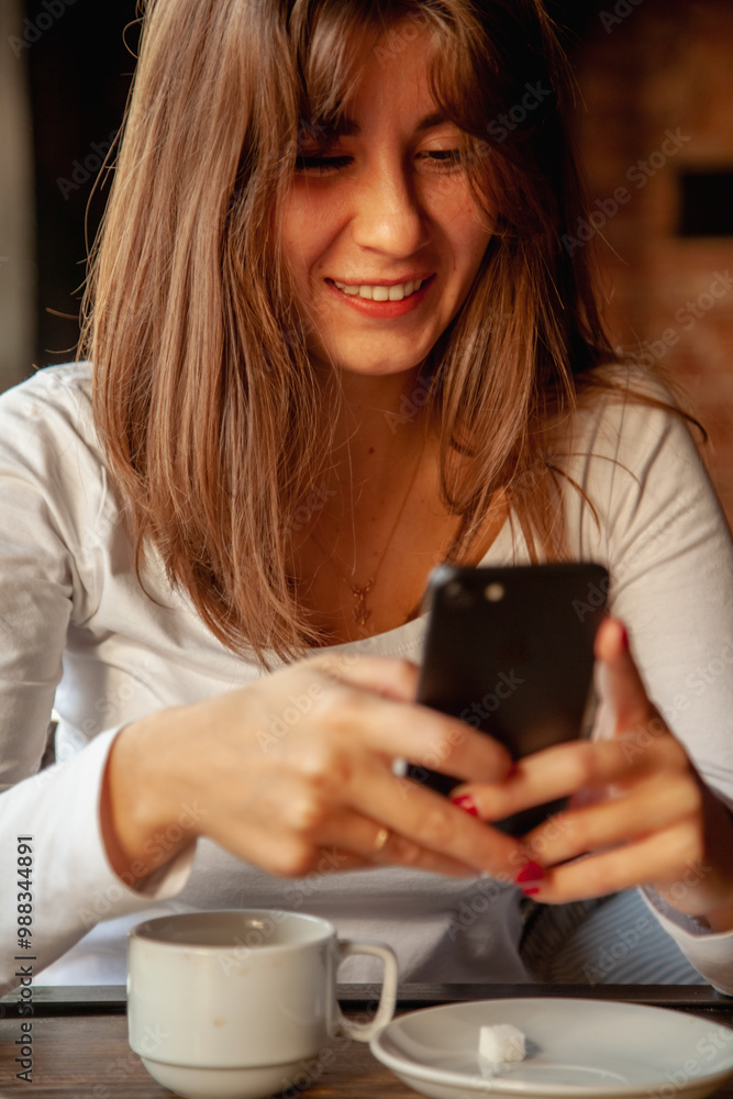 Young beautiful woman beaming with happiness, she talks to relatives on the phone. Young beautiful woman beaming with happiness, she talks to relatives on the phone.