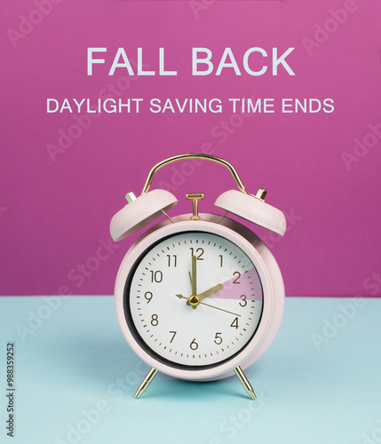 Fotografie End of daylight saving time in fall, winter time changeover, alarm clock, autumn