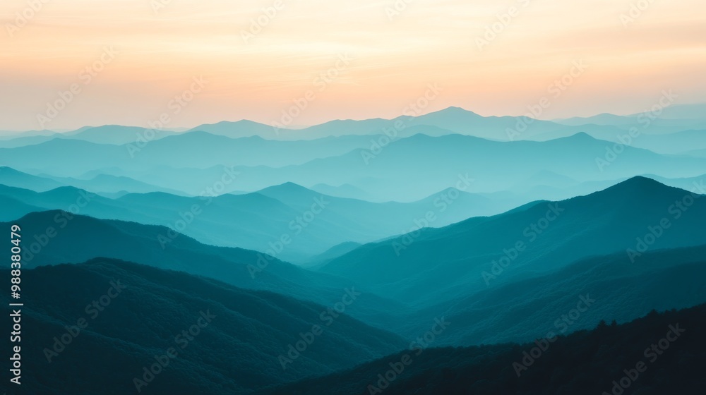 Sunset over distant mountains with layered blue hues and soft twilight colors in a serene landscape Sunset over distant mountains with layered blue hues and soft twilight colors in a serene landscape