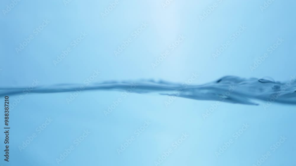 Close-up of a Water Splash in Slow Motion. Crystal Clear Droplets Against White Background. Close-up of a Water Splash in Slow Motion. Crystal Clear Droplets Against White Background.
